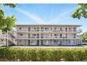 Exterior showcasing modern building design with multiple balconies and outdoor living spaces, surrounded by beautiful landscaping at 320 Lakeview St # 222, Orlando, FL 32804
