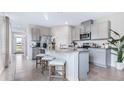Modern kitchen with granite countertops, stainless steel appliances, and a central island with barstool seating at 3206 Partington Blvd, Davenport, FL 33837