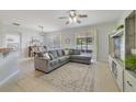 Spacious living room boasts a comfortable gray sofa, tile floors, and a seamless flow to the dining area at 4544 Point Look Out Rd, Orlando, FL 32808
