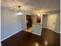 Open-concept dining and kitchen area with modern lighting, hardwood floors, and stainless appliances at 5160 Conroy Rd # 1423, Orlando, FL 32811
