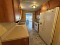 Galley kitchen with a refrigerator, stove, microwave, and lots of cabinet space at 551 Pine Needle Ct, Lake Mary, FL 32746