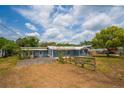 Charming single-story home with blue siding, a gravel driveway, and a beautiful lawn at 55119 5Th St, Astor, FL 32102