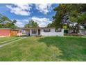 Single-story home featuring a well-maintained lawn and a classic exterior at 5601 Andora St, Orlando, FL 32807