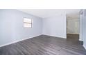 A bright living room with modern gray wood laminate flooring at 5601 Andora St, Orlando, FL 32807