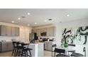 Spacious kitchen featuring modern appliances, an island with seating, and lots of cabinet space at 5657 Loggia Ln, Kissimmee, FL 34758