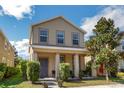 Inviting two-story home with a covered front porch, perfect for enjoying neighborhood views at 6822 Habitat Dr, Harmony, FL 34773