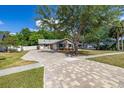 Charming home with brick accents, a spacious two-car garage, and a long beautifully paved driveway at 694 Tuscora Dr, Winter Springs, FL 32708