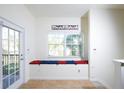 Cozy sitting area with a window seat and decorative pillows next to a door leading to a balcony at 7505 Pellham Way, Kissimmee, FL 34747
