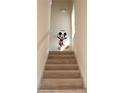 Bright staircase featuring wood steps and white railing, decorated with a playful Mickey Mouse decal at 7505 Pellham Way, Kissimmee, FL 34747