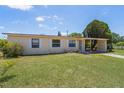 Cozy single-story home with a covered carport and a neatly manicured lawn at 7700 Grevillea Dr, Orlando, FL 32822