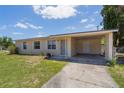 Inviting single-story home featuring a covered carport and a driveway at 7700 Grevillea Dr, Orlando, FL 32822