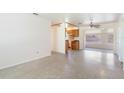 Spacious living area with terrazzo flooring, connecting to the kitchen at 7700 Grevillea Dr, Orlando, FL 32822