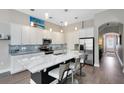 Modern kitchen featuring stainless steel appliances, a large island, and white cabinetry at 8263 Bellow St, Orlando, FL 32827