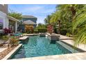 Beautiful backyard pool and patio surrounded by lush landscaping, perfect for outdoor entertaining at 8263 Bellow St, Orlando, FL 32827
