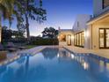 Beautiful pool with elegant patio and landscaping, seamlessly blending indoor and outdoor living at 9364 Thurloe Pl, Orlando, FL 32827