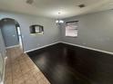 Elegant dining room with dark floors, modern lighting, and an open layout at 10414 Andover Point Cir, Orlando, FL 32825