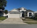 Beautiful home with a two-car garage, well-kept lawn, and inviting curb appeal at 10414 Andover Point Cir, Orlando, FL 32825