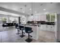 Bright kitchen features a breakfast bar with seating, modern appliances, and views into the dining area at 11407 Wakeworth St, Orlando, FL 32836