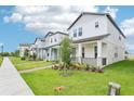 A row of inviting two-story homes, each featuring a well-kept lawn and charming landscaping at 11941 Bracco St, Winter Garden, FL 34787