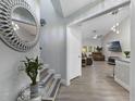 The foyer features stylish flooring and leads to the open-concept living space at 12133 Augusta Woods Cir, Orlando, FL 32824