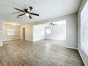 Spacious living room with modern flooring, neutral paint, and abundant natural light at 130 Aragon Ave, Umatilla, FL 32784