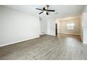 Bright and airy living room featuring modern floors and a ceiling fan at 130 Aragon Ave, Umatilla, FL 32784