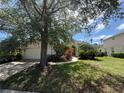 This home boasts a large tree and a beautifully landscaped front yard at 13250 Meergate Cir, Orlando, FL 32837