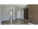 Bright living area boasts updated flooring and neutral paint, with built-in shelving adding character at 159 Piccolo Way, Davenport, FL 33896