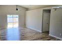 Spacious living room featuring luxury vinyl flooring and a sliding glass door to the outdoor space at 159 Piccolo Way, Davenport, FL 33896