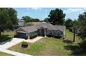 Beautifully landscaped front yard leading to the home's inviting entrance and attached garage at 15910 Mercott Ct, Clermont, FL 34714