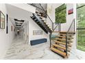 Elegant foyer with marble flooring, open staircase, and an abundance of natural light from large windows at 1624 E Livingston St, Orlando, FL 32803