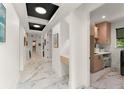 Well-lit hallway features marble floors and leads to a conveniently located laundry room at 1624 E Livingston St, Orlando, FL 32803