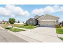 Beautifully landscaped single-story home with a well-manicured lawn and a two-car garage at 1703 Daystar Dr, Haines City, FL 33844