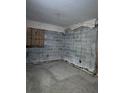 Unfinished basement with exposed concrete walls and boarded window at 2115 Messina Ave, Orlando, FL 32811
