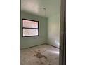 Empty bedroom features an boarded window and needs renovations at 2115 Messina Ave, Orlando, FL 32811