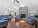 Open living room showcasing a marble fireplace, modern seating, and hardwood flooring at 226 Ringwood Dr, Winter Springs, FL 32708