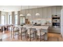 Elegant kitchen with marble countertops, pendant lighting, and stainless steel appliances at 2612 Musselwhite Ave, Orlando, FL 32804