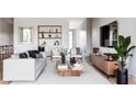 Bright living room with white sofa, built-in shelves, and modern decor at 2612 Musselwhite Ave, Orlando, FL 32804