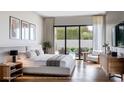 Spacious bedroom featuring hardwood floors, a king-size bed, and sliding glass doors to the backyard at 2612 Musselwhite Ave, Orlando, FL 32804