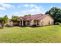Lovely single-Gathering home with a well-kept lawn, complemented by mature trees and landscaped features at 2726 La Alameda Ave, Kissimmee, FL 34746