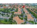 Aerial view of condo community with lush landscaping, sparkling lake, and convenient parking at 2785 Almaton Loop # 202, Kissimmee, FL 34747