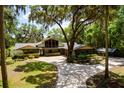 Stunning single-story home with mature trees, inviting driveway, and lush landscaping create curb appeal at 3359 Scarlet Dr, Sanford, FL 32773