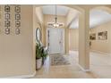 Bright foyer with a white front door, neutral walls, tile floors, and decorative art at 5062 Otters Den Trl, Sanford, FL 32771
