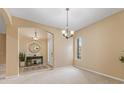 Neutral living room with archway, window, light carpet, and entrance to the foyer at 5062 Otters Den Trl, Sanford, FL 32771