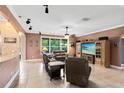 Inviting living room featuring tile flooring and comfortable leather seating with a window overlooking the outdoors at 613 Crownclover Ave, Orlando, FL 32828