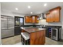 Well-appointed kitchen with an island, stainless steel fridge, and a wine cooler for entertaining at 613 Lake Ave, Altamonte Springs, FL 32701