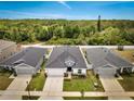 Aerial view of a well-maintained home with landscaped yard, nestled in a serene neighborhood at 62 Polermo Ave, St Cloud, FL 34771