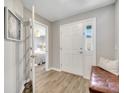 Inviting foyer with wood flooring, neutral paint, and a view into the bedroom at 62 Polermo Ave, St Cloud, FL 34771