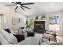 Cozy living room boasts a fireplace, hardwood floors, natural light, and contemporary furnishings at 7025 Hiawassee Oak Dr, Orlando, FL 32818