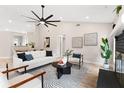 Bright and airy living room with modern decor, a ceiling fan, hardwood floors and an open floor plan at 7025 Hiawassee Oak Dr, Orlando, FL 32818